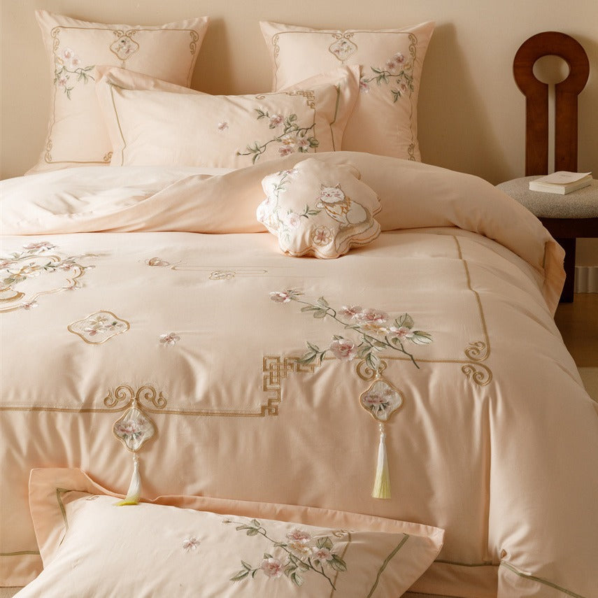 Luxurious cotton satin bedding set with fine embroidery, floral motifs, and decorative pillows