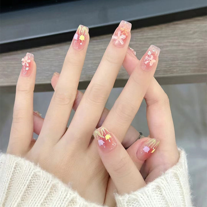 Artificial nails with floral design and glitter effects Stornfield