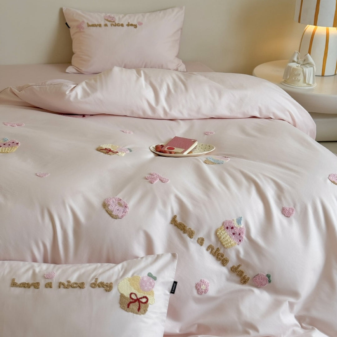 Quilted bedding set with cupcake embroideries and text application