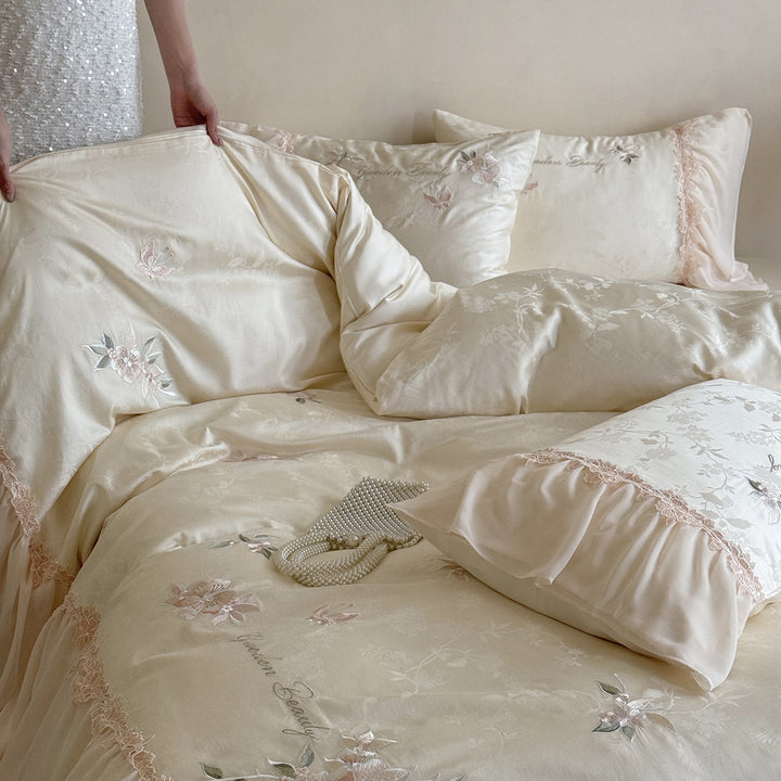 Romantic satin bedding set with embroidered floral design, ruffle and pillowcases