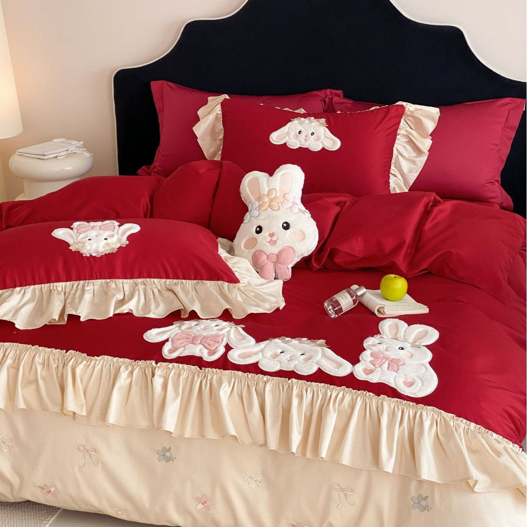 Playful bedding set with ruffles, three-dimensional appliqués, and delicate embroidery