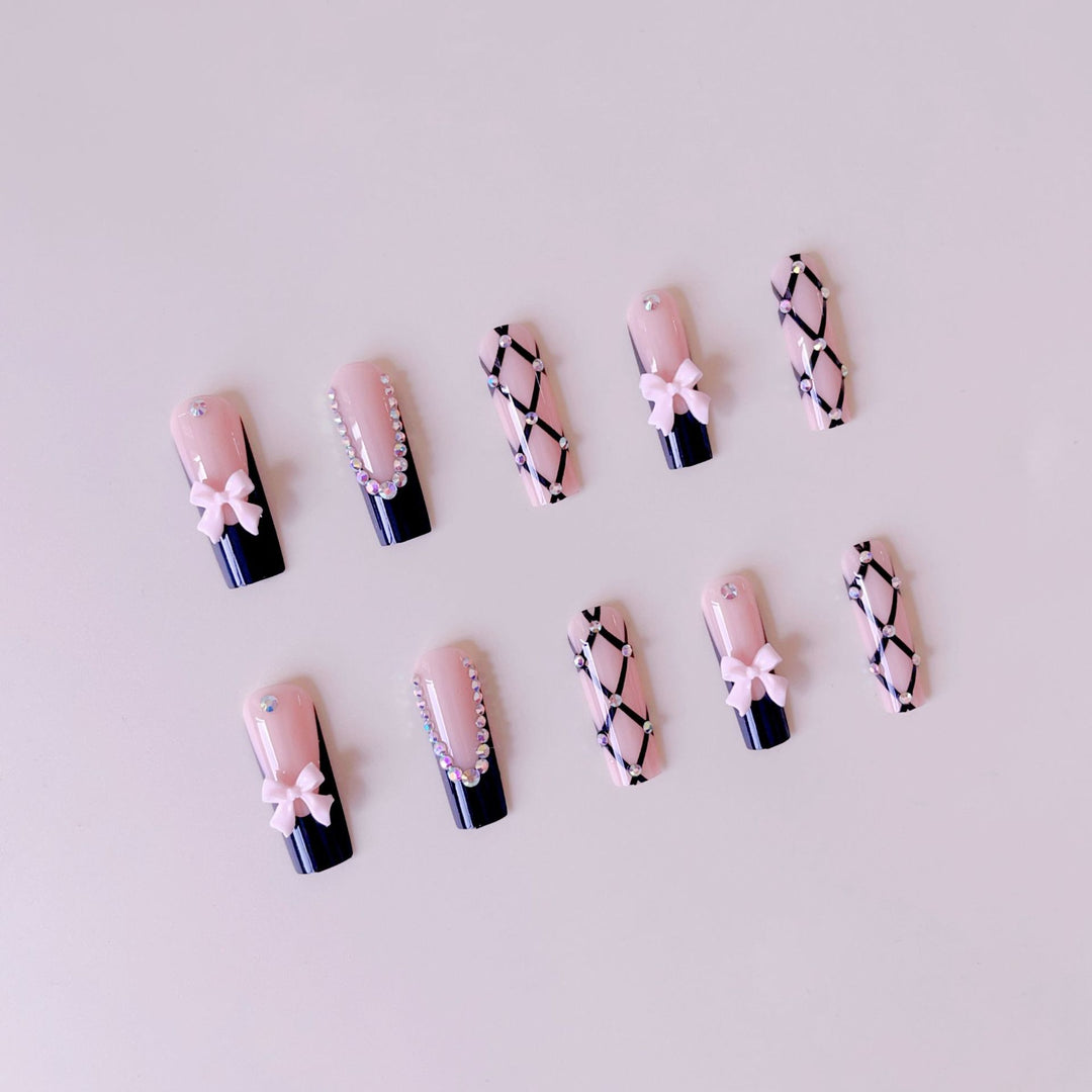 Artificial nail set with glamorous rhinestone and bow accents Stornfield