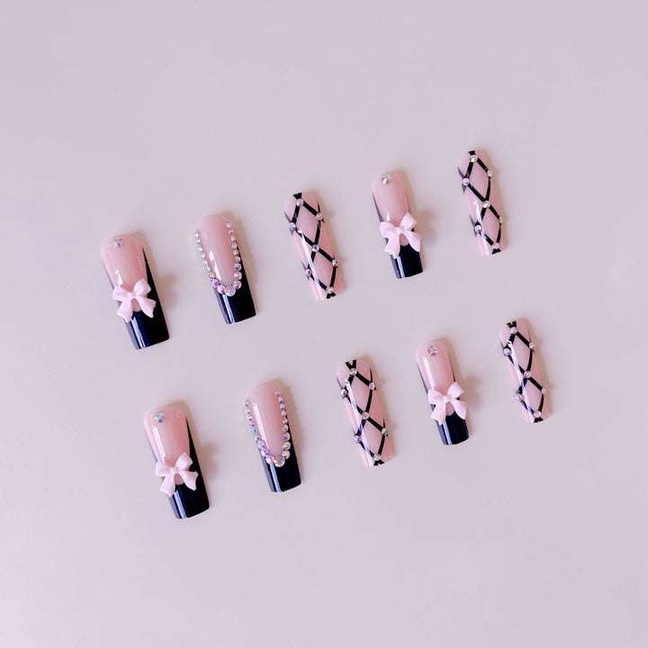 Artificial nail set with glamorous rhinestone and bow accents Stornfield