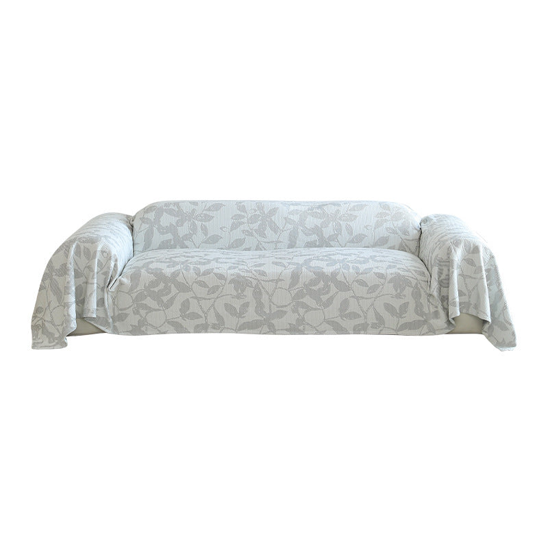 Universal sofa cover with floral relief and elastic hem