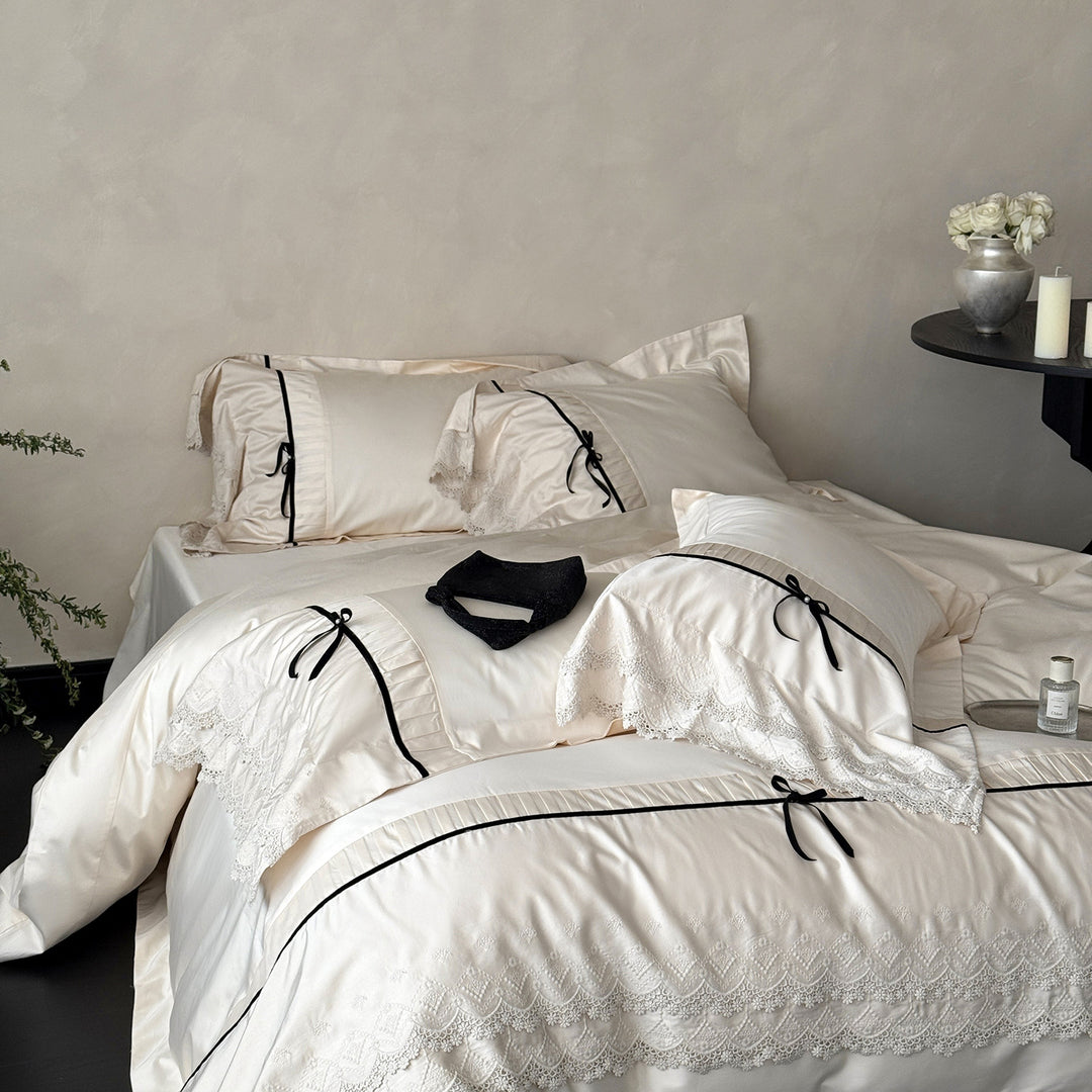 Romantic satin bedding set with lace trim, pleated detail and satin bows