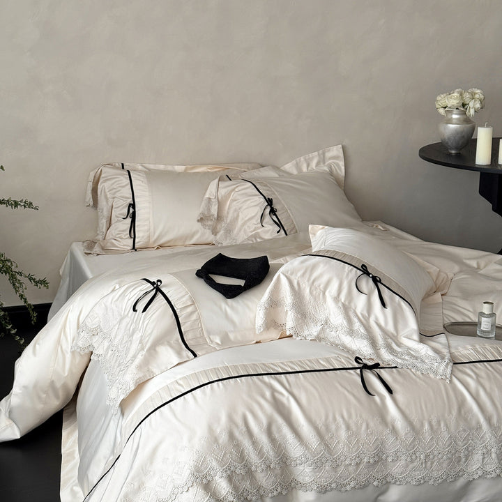 Romantic satin bedding set with lace trim, pleated detail and satin bows