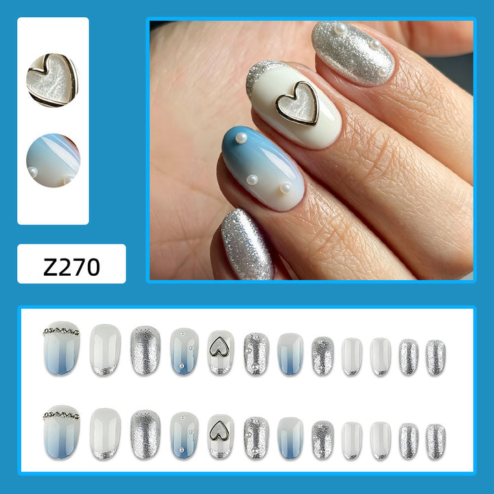 Glamorous artificial nails with heart design and pearl details Stornfield