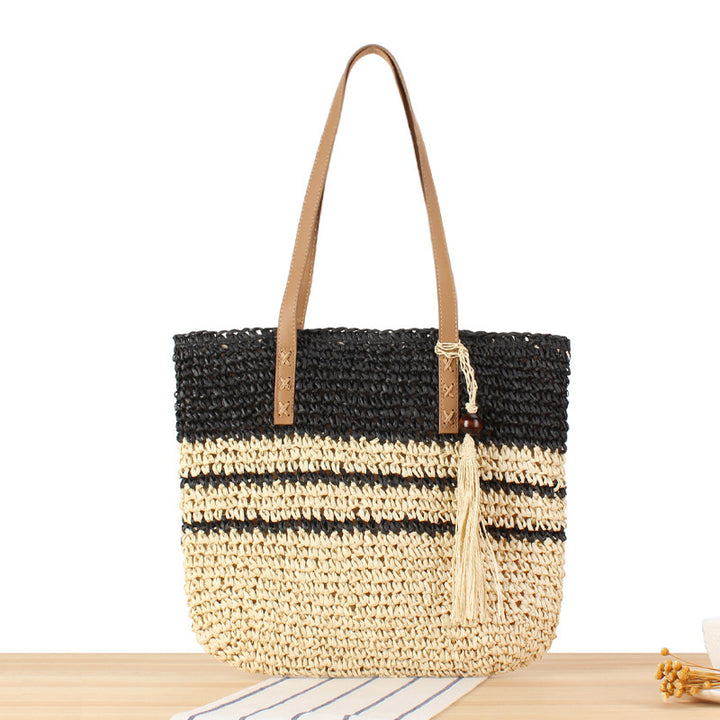 Handbag made of braided natural material with decorative tassel pendant Stornfield