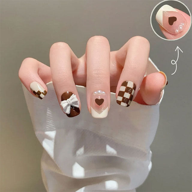 Glamorous artificial nails with heart design and glittering accents Stornfield