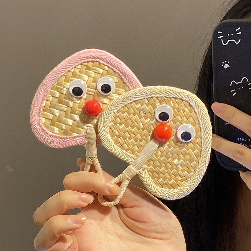 Handcrafted fan with playful face motif Stornfield