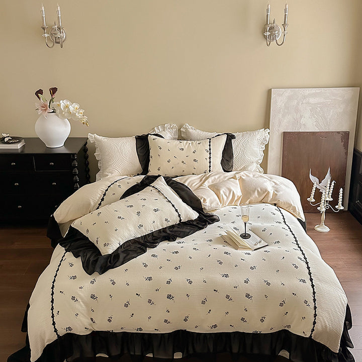 Country house bedding set with quilted bedspread, delicate rose print and ruffle trim