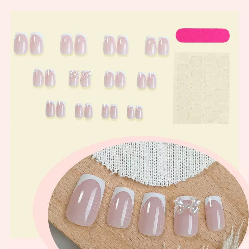 Artificial nail set with glamorous French tips and sparkling accents Stornfield