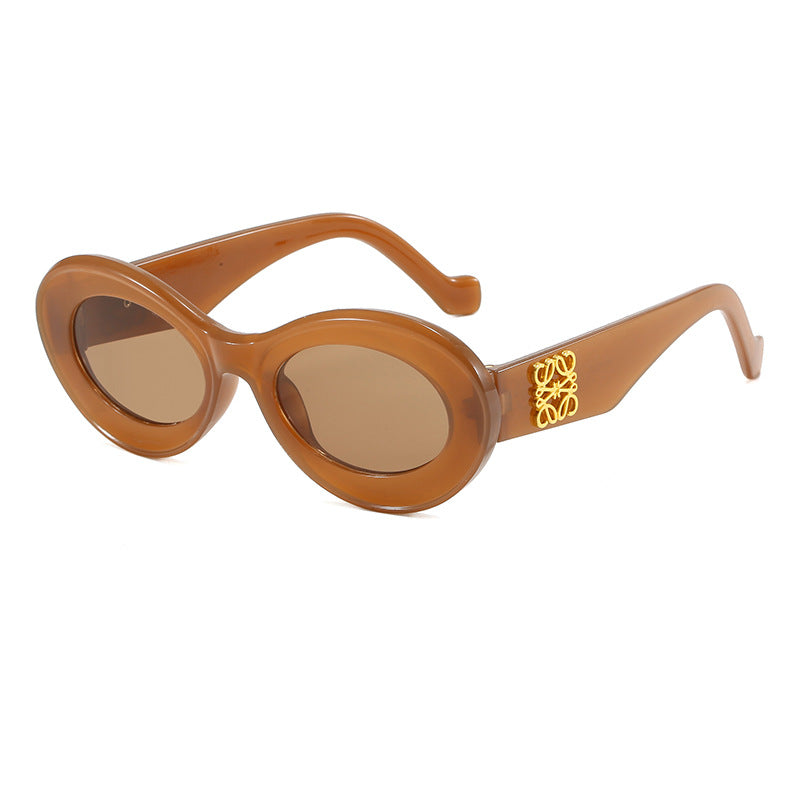 Women's fashionable sunglasses with oval frame and golden applications Stornfield