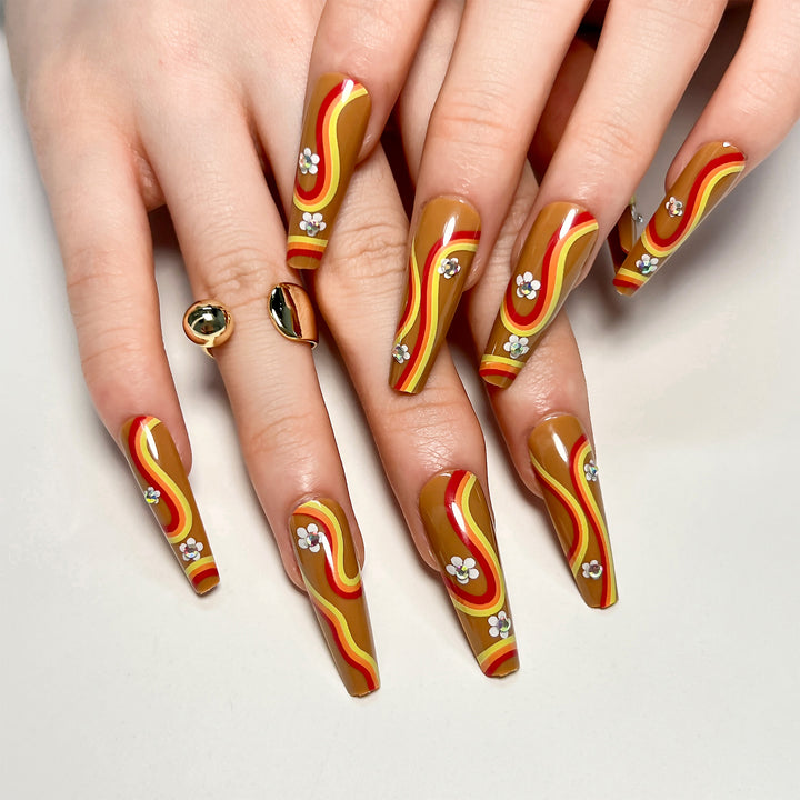 Artful acrylic nails with wave design and floral embellishments Stornfield