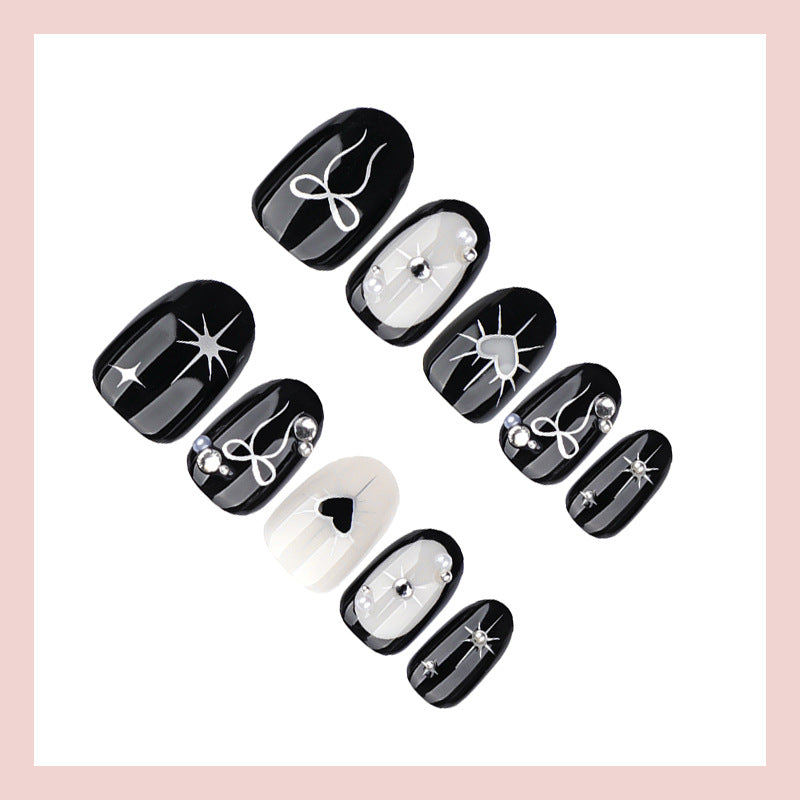 Artificial nail set with elegant bow and heart design Stornfield