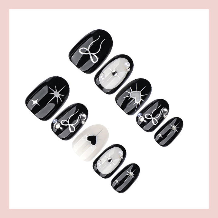 Artificial nail set with elegant bow and heart design Stornfield