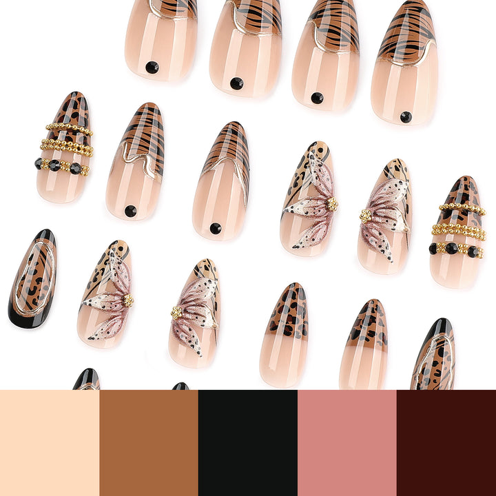 Artful stiletto nail with floral accents and gold embellishments Stornfield