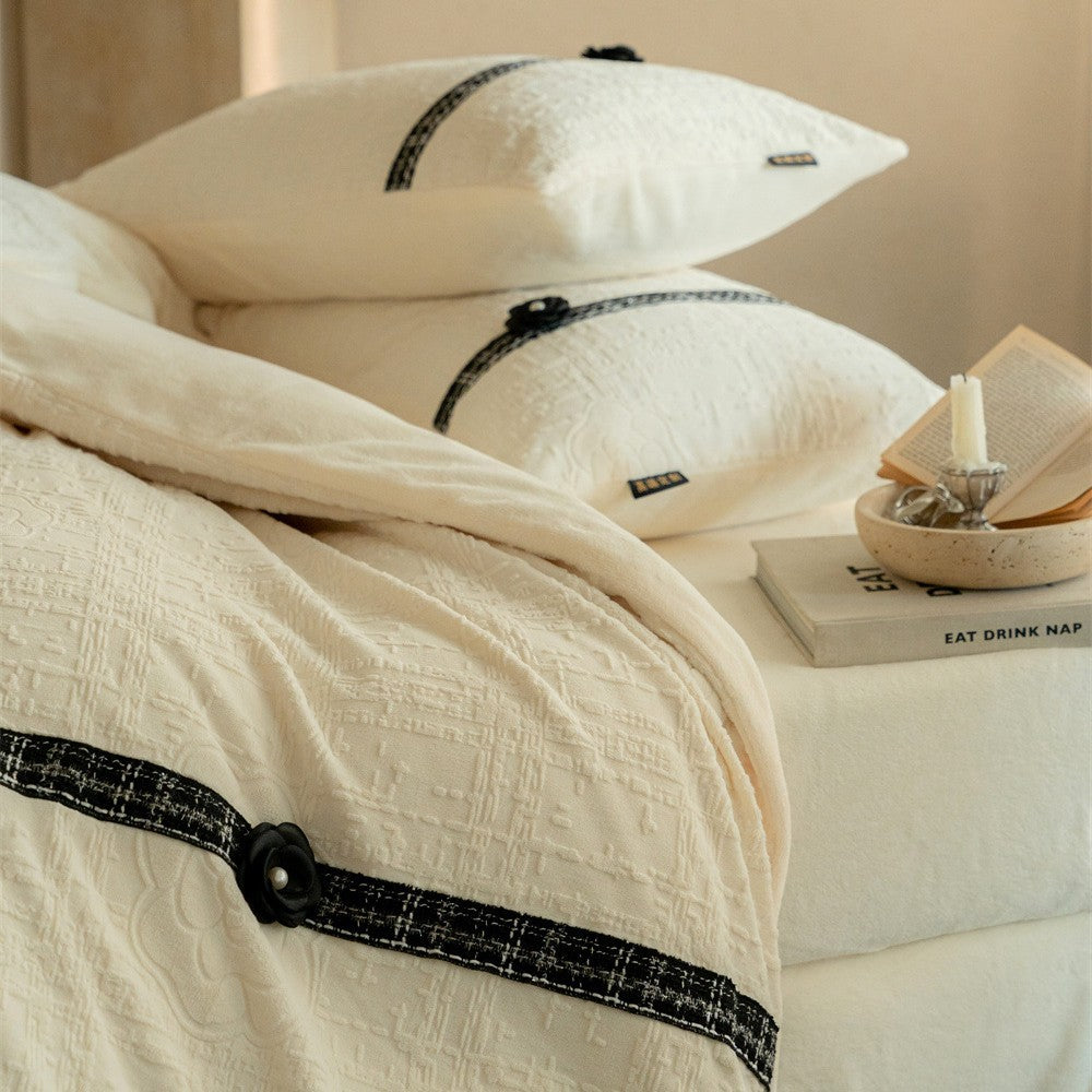 Quilted bedding set with decorative contrast ribbon and button closure