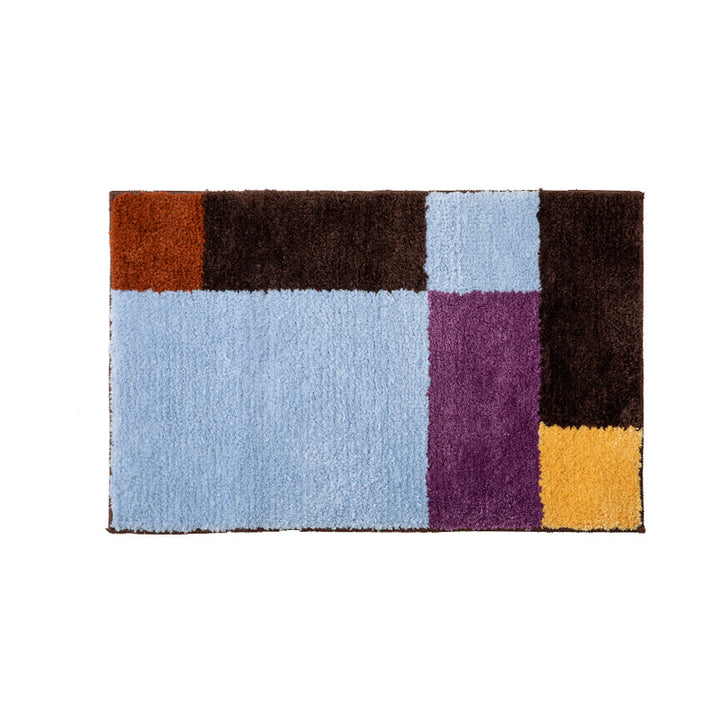High-pile bath mat with geometric color block design and non-slip underside