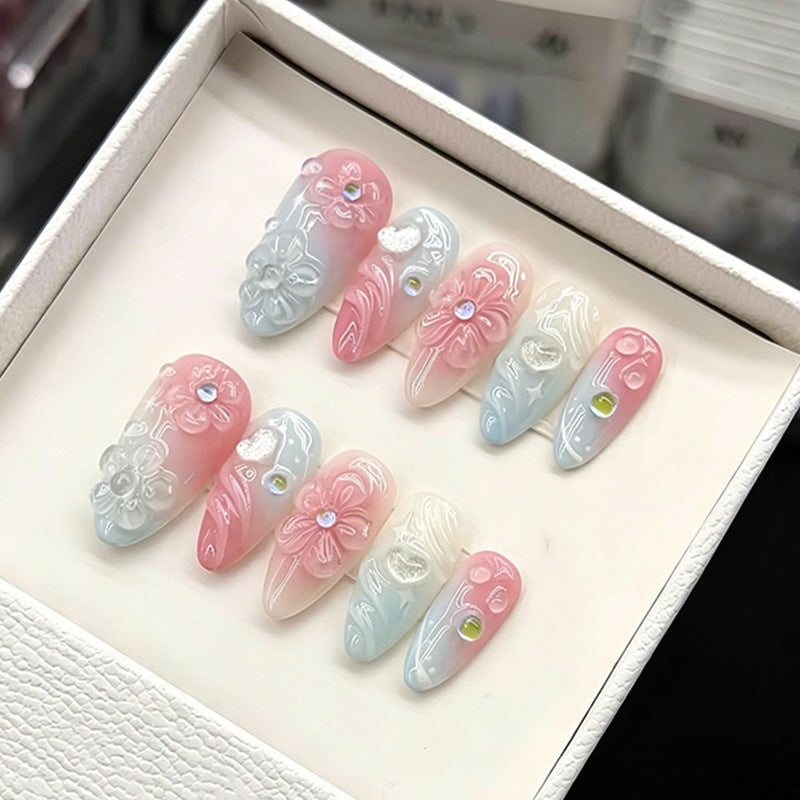 Acrylic nail set with elegant ombre design and floral decorations Stornfield