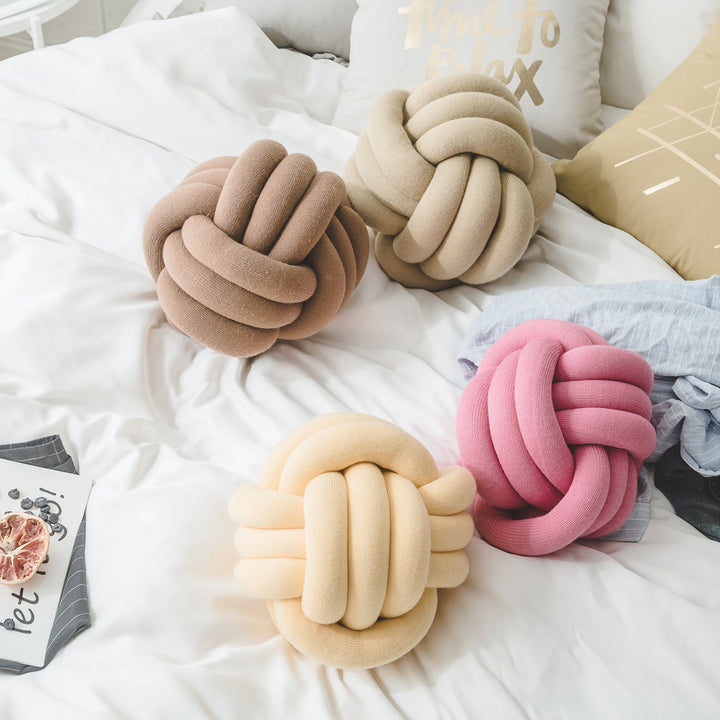 Decorative knitted knot cushion as a decorative pillow made of soft jersey