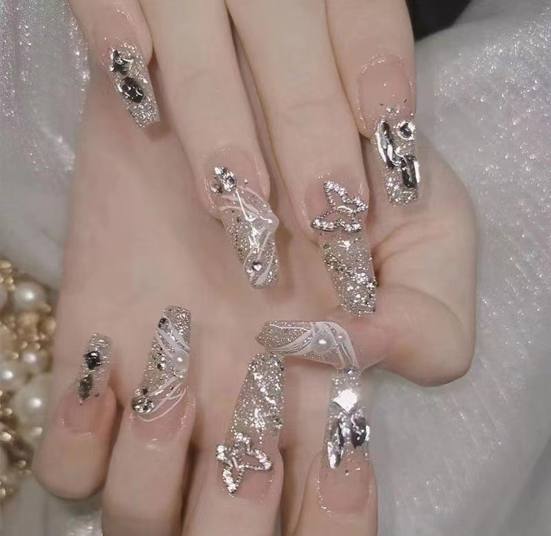 Artistic Nail Art with Glitter and Flower Applications Stornfield