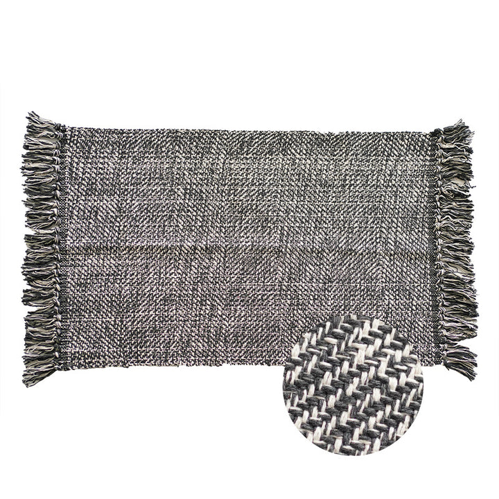 Handwoven table runner in herringbone pattern with decorative fringes
