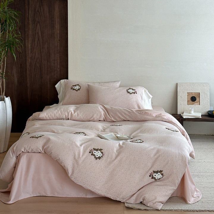 Embroidered bed set made of fine cotton satin with gathered bed skirt and decorative pillows