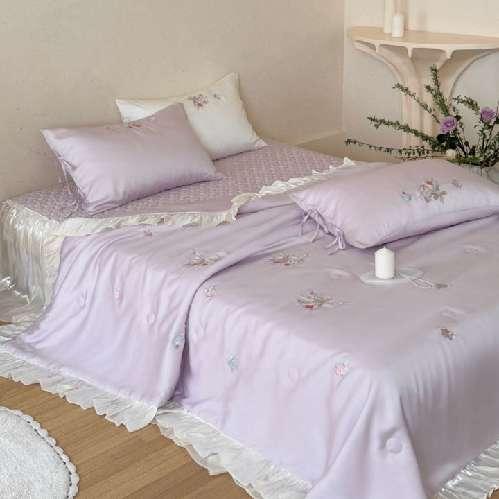 Romantic satin bedding set with ruffle, floral embroidery and tie pillow