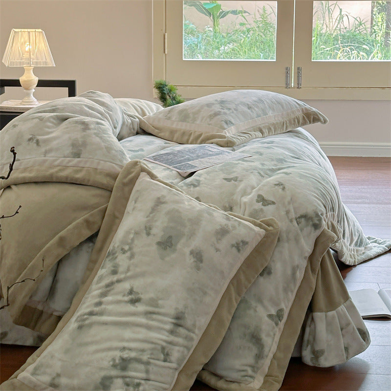Luxurious quilted bedding set with velvet trim and floral branch motif