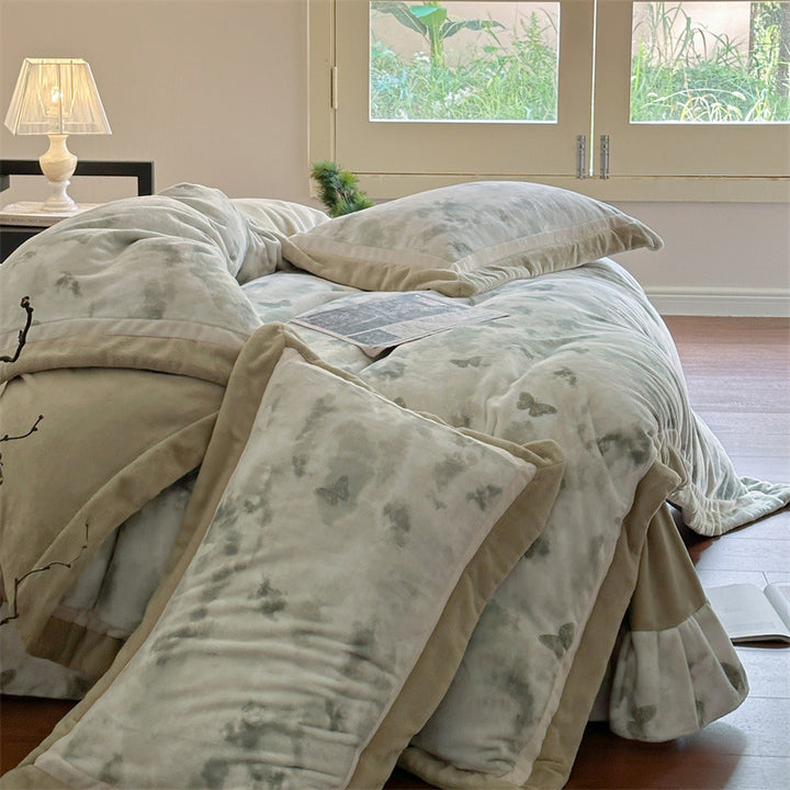 Luxurious quilted bedding set with velvet trim and floral branch motif