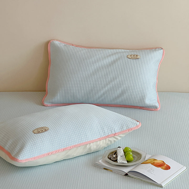 Cooling waffle structure pillow with breathable filling core and decorative piping
