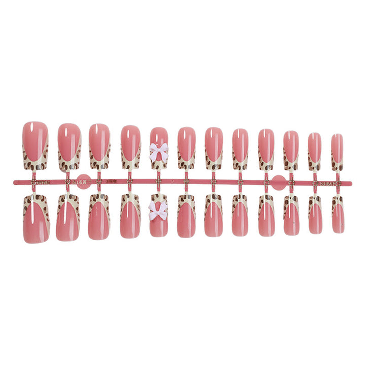 Nail set with elegant leopard accents and bow embellishments Stornfield