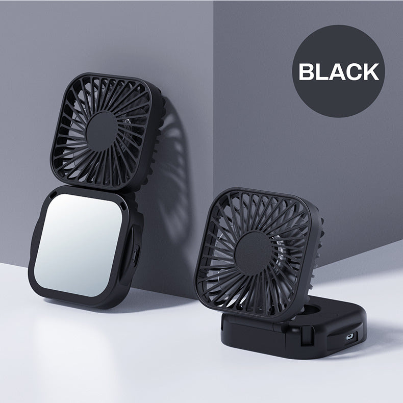 Unisex nan compact foldable clip on handheld desk fan with built in mirror adjustable tilt and USB rechargeable battery Stornfield