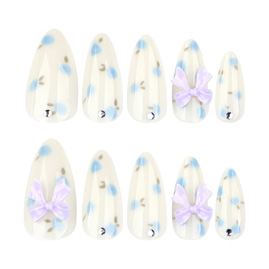 Artful stiletto nails with delicate flower patterns and glitter accents Stornfield