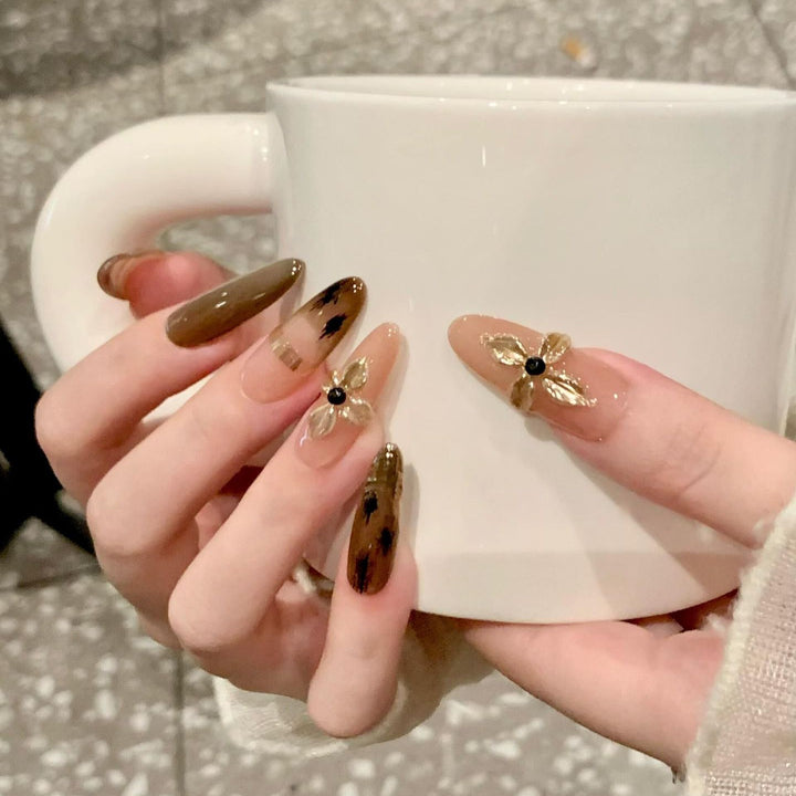 Artificial nails with elegant gold embellishments Stornfield