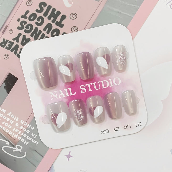 Artistic acrylic nails with heart-shaped accents Stornfield