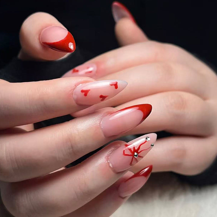 Artificial nails with elegant heart designs and glamorous accents Stornfield