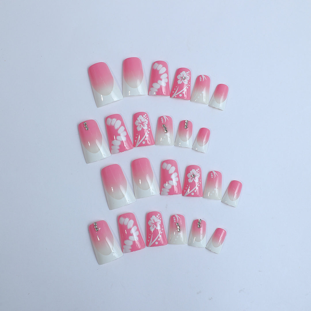 Acrylic nail set with elegant floral designs and glitter accents Stornfield