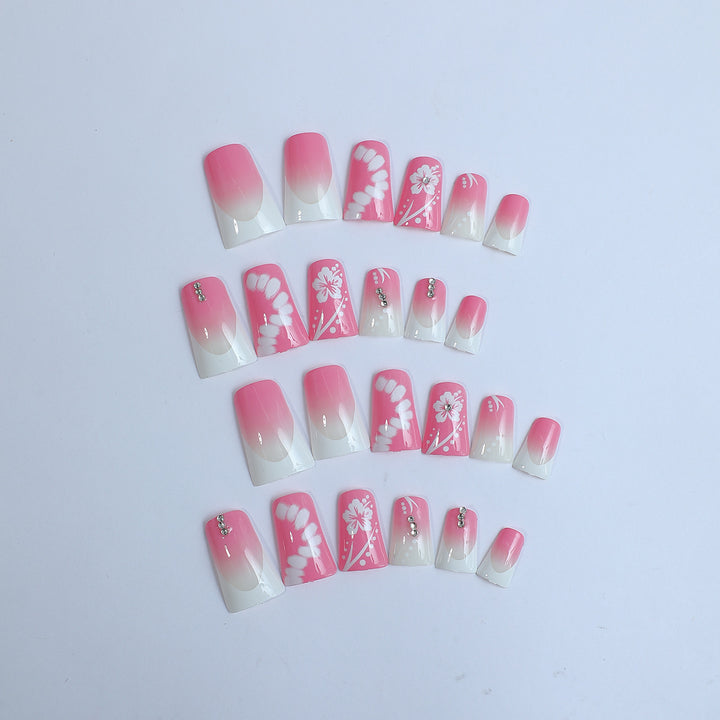 Acrylic nail set with elegant floral designs and glitter accents Stornfield