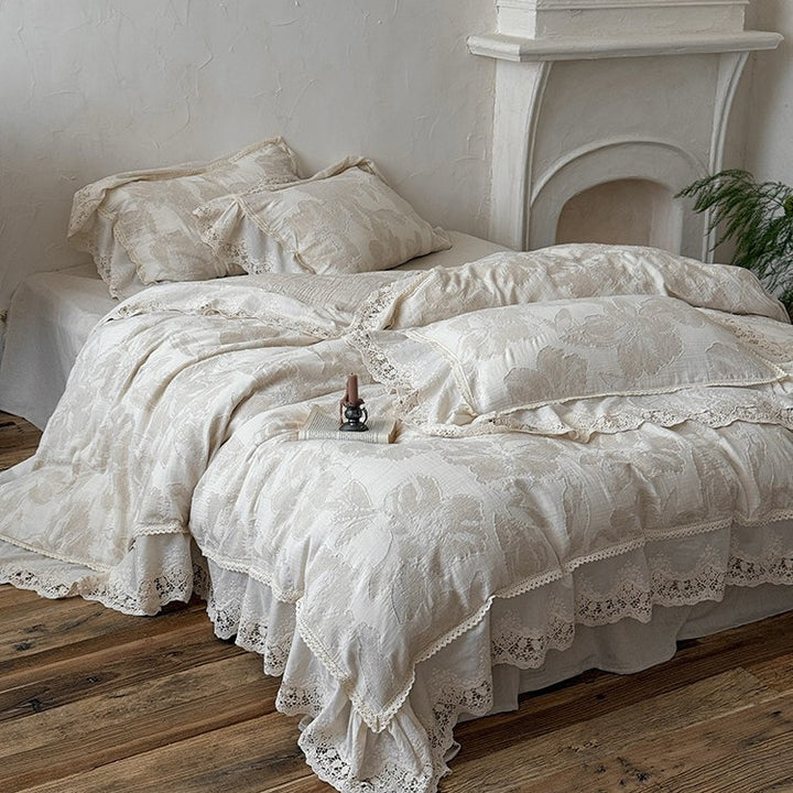 Vintage-inspired cotton-linen bedding set with large floral pattern, ruffle, and lace appliqué