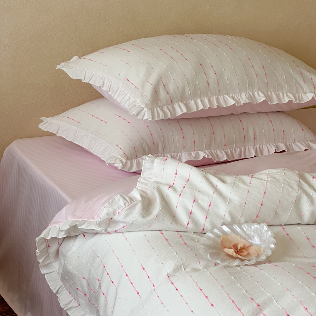 Bedding set made of lightweight cotton muslin with fine line embroidery and ruffled border