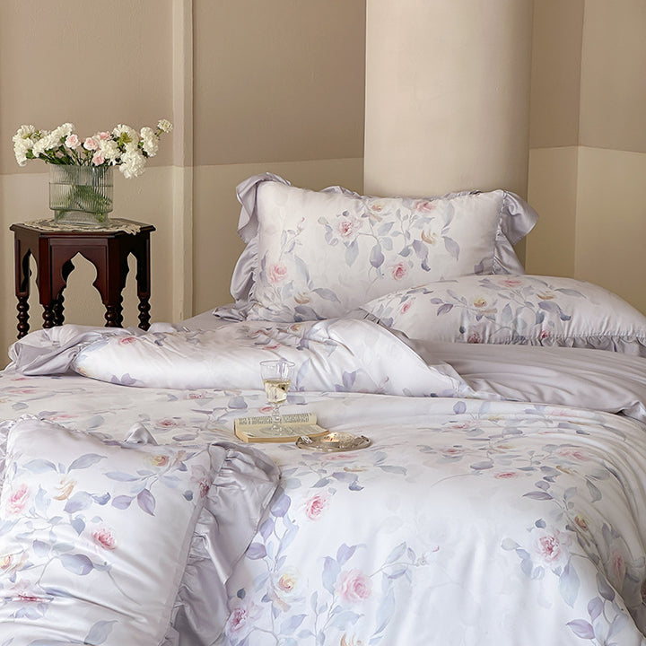 Luxurious satin bedding set with ruffled pillows and delicate watercolor rose print
