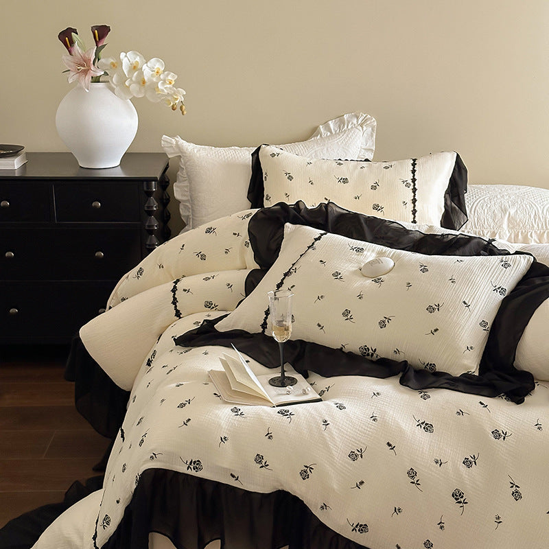 Country house bedding set with quilted bedspread, delicate rose print and ruffle trim