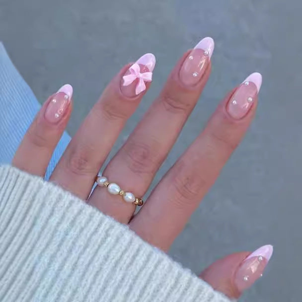 Artificial nail set with shimmering 3D bows and elegant pearl accents Stornfield
