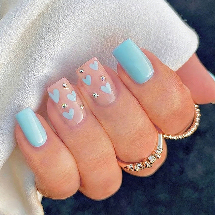 Nail art with heart designs and glitter accents Stornfield
