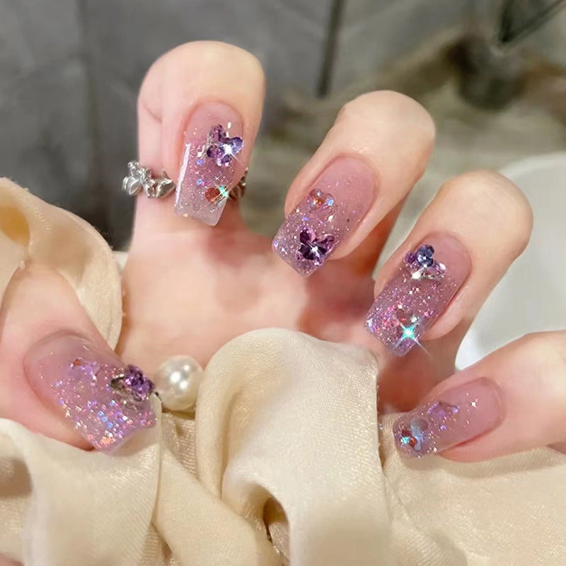 Glamorous artificial nails with glitter and floral accents Stornfield
