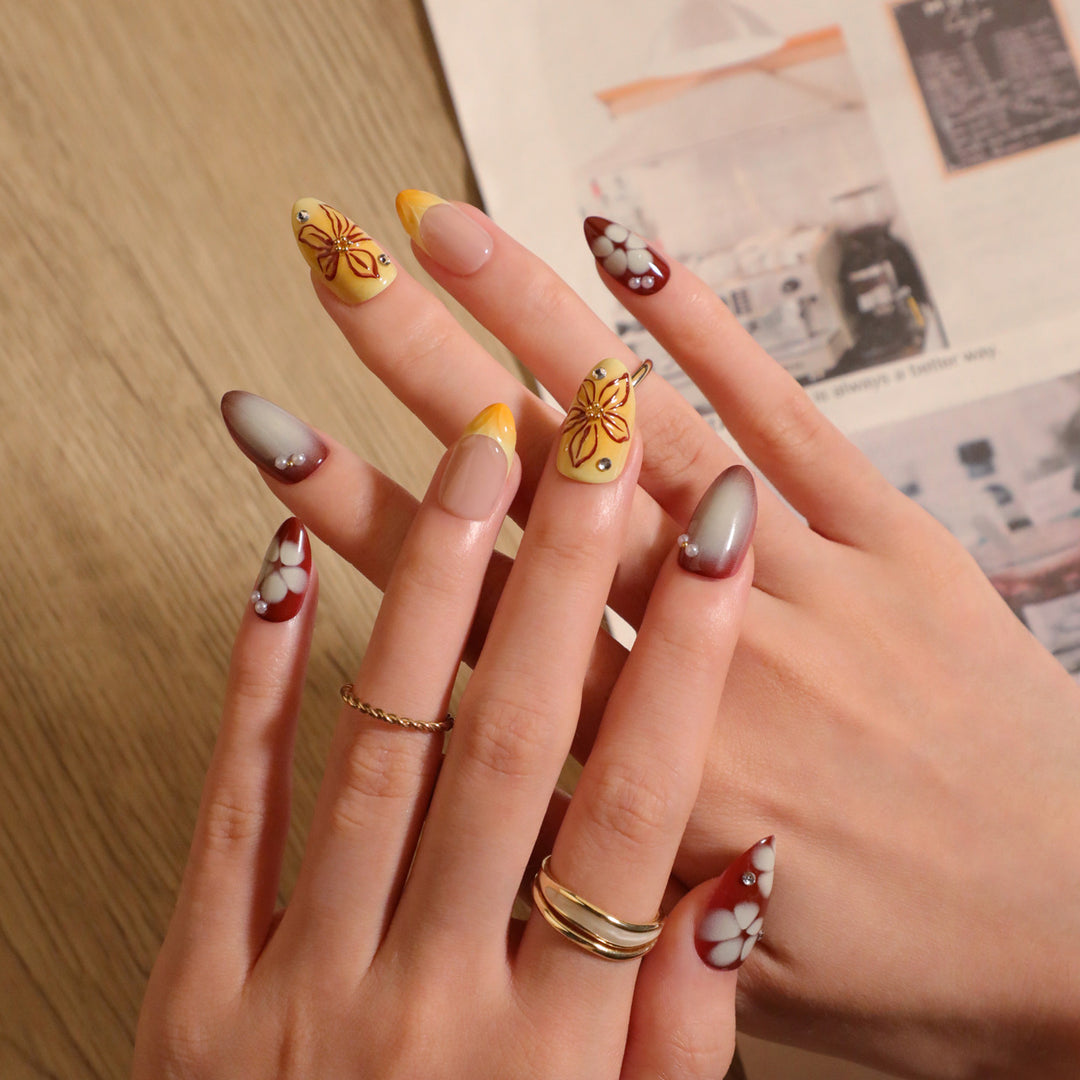 Artificial nail extensions with floral design and rhinestone embellishments Stornfield