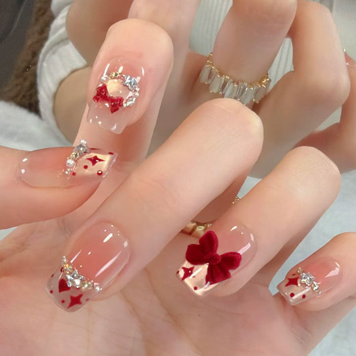 Artificial nail set with festive gift design and elegant glitter accents Stornfield