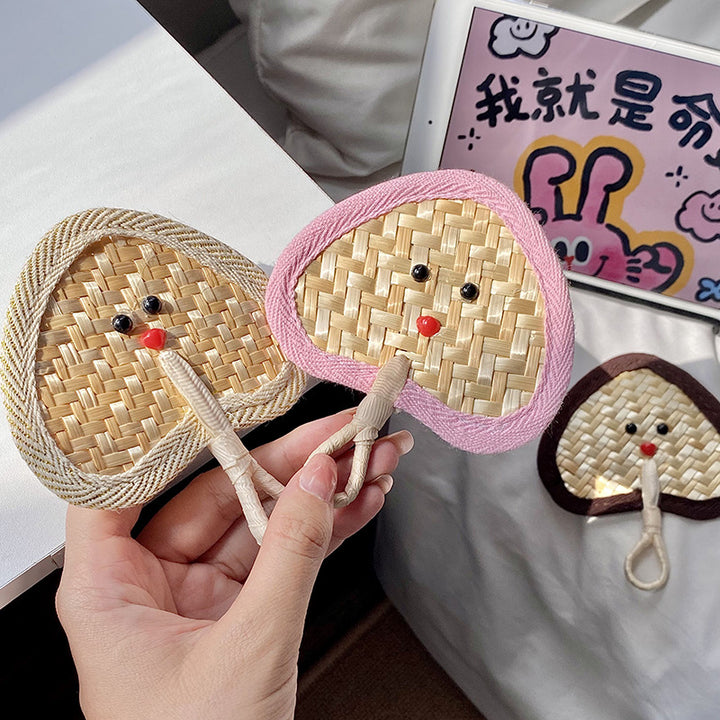 Handcrafted fan with playful face motif Stornfield